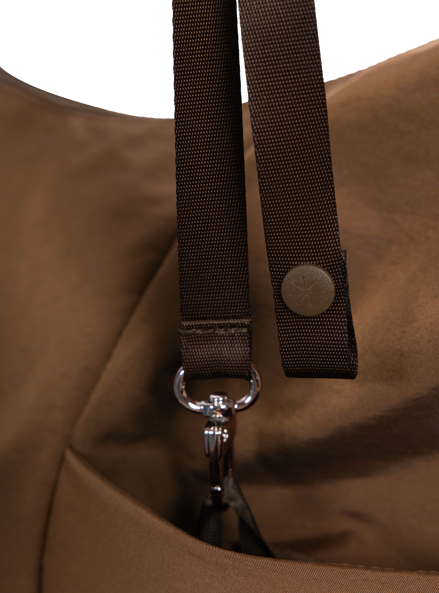 Exterior pocket of the Arc hobo-style bag in chocolate brown nylon with concealed snap loop