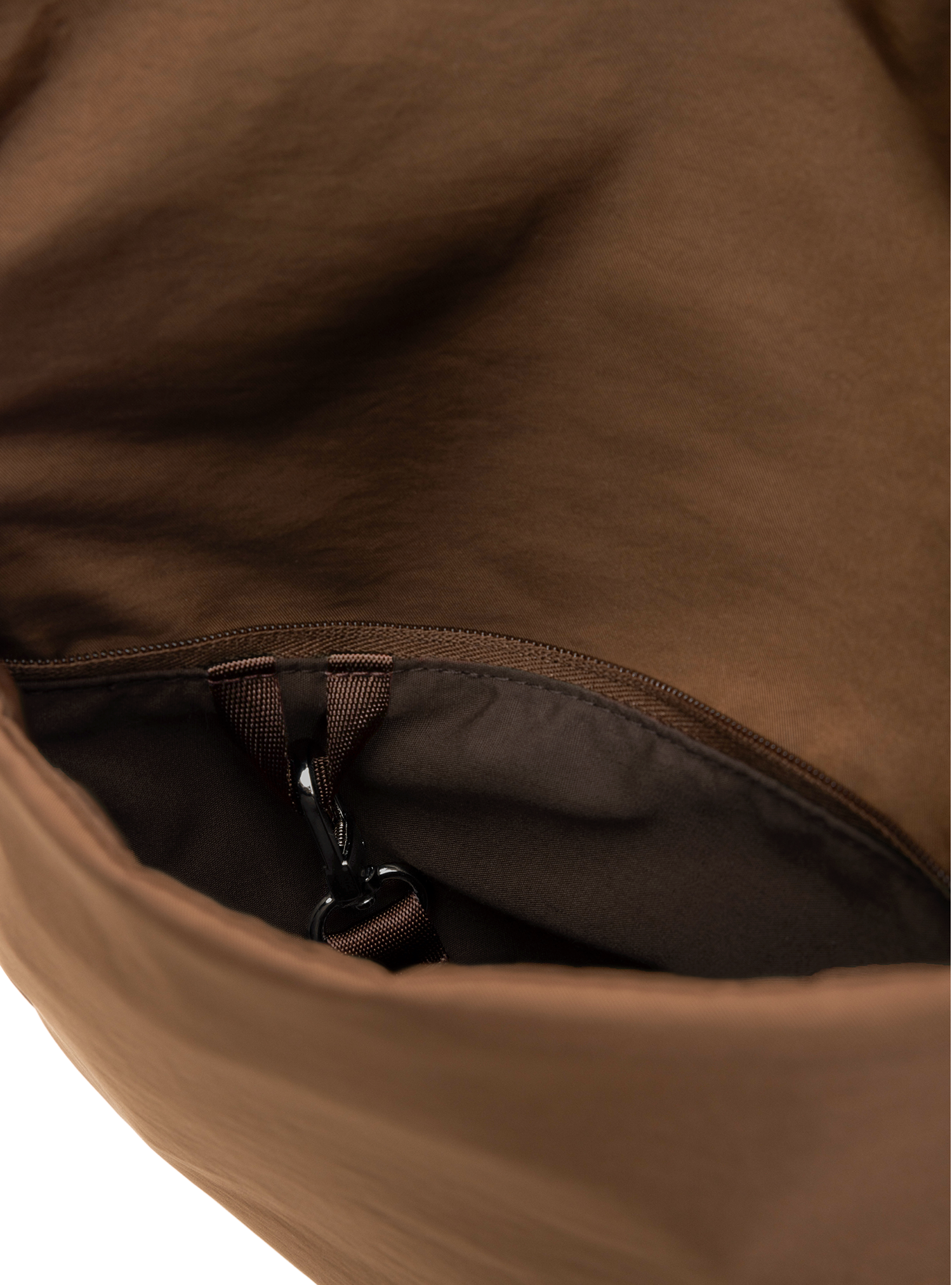 Exterior pocket of the Arc hobo-style bag in chocolate brown nylon with concealed snap loop
