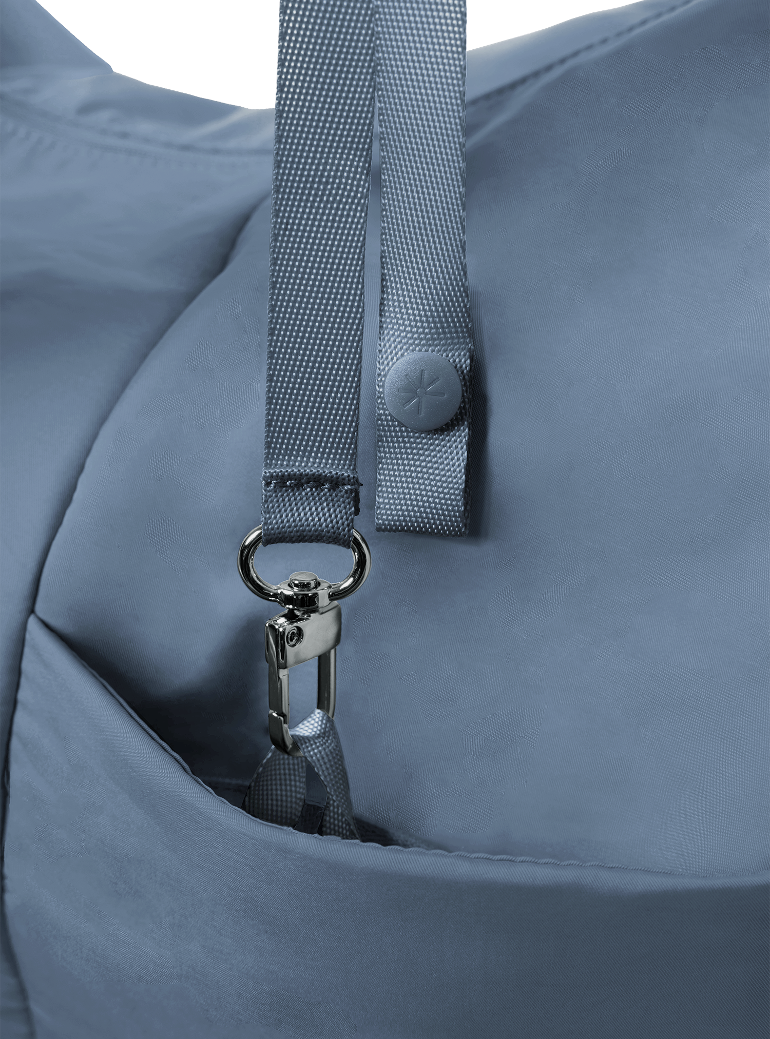 Exterior pocket of the Arc hobo-style bag in grey blue nylon, with concealed snap loop
